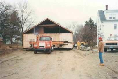 front view of truck hauling wooden structure