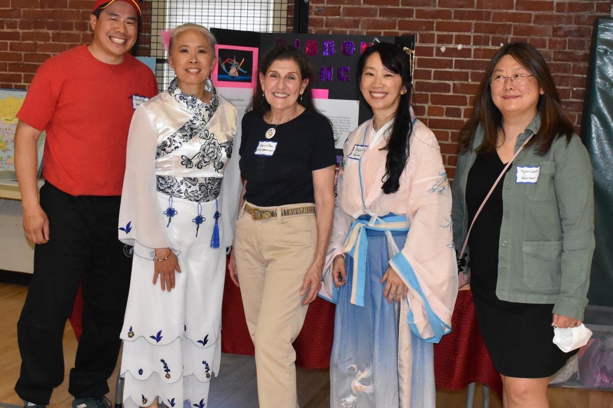 five adults smile for the camera at Asian/Pacific American Heritage event