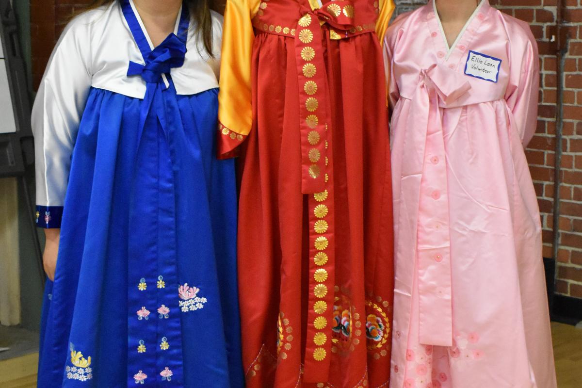 two women in traditional Korean robes in blue and pink